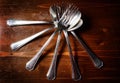 Old used cutlery on dark wooden table Royalty Free Stock Photo