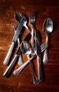 Old used cutlery on dark wooden table Royalty Free Stock Photo