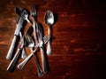 Old used cutlery on dark wooden table Royalty Free Stock Photo