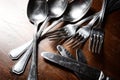 Old used cutlery on dark wooden table Royalty Free Stock Photo