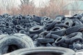 Old used damaged car tires at the dump