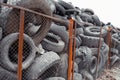 Old used damaged car tires at the dump