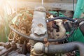 Close-up of an old used diesel engine with rusty and dirty car parts, water infiltration and poor car maintenance