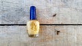 old used dirty nail polish bottle on wood cement background