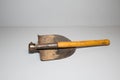 Old, used folding sapper, engineer`s shovel. Compact and universal shovel that takes up little space Royalty Free Stock Photo