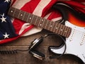 Old used guitar with headphones and American flag Royalty Free Stock Photo