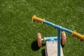 Old and used old metal and plastic scooter on artificial grass Royalty Free Stock Photo