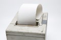 Old used receipt printer looking onto the top side of this device, with  a mounted paper roll,  copy space, thermal paper rusty Royalty Free Stock Photo
