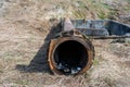 Old , used rusty sewage water pipe near concrete pit Royalty Free Stock Photo