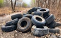Old used tires dumped in the forest. A pile of old tires at an industrial facility Royalty Free Stock Photo