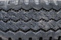 Old used tires stacked with high piles. close up damaged worn black tire tread car. Royalty Free Stock Photo