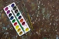 Old used watercolor paint palette, old vintage brushes for drawin Royalty Free Stock Photo