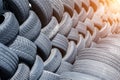 Old used weared car and truck wheels tyres pile stacked in rows stored for recycling. Heap of many rubber tires wall Royalty Free Stock Photo