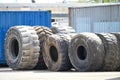 Old used weared car and truck wheels tyres pile stacked in rows stored for recycling. Heap of many rubber tires wall Royalty Free Stock Photo