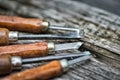 Old used wood chisels selection on the wooden table Royalty Free Stock Photo