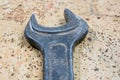 Old used wrench on a cork background. Vintage spanner