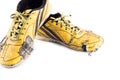 Old used yellow worn out futsal sports shoes on white background soccer sportware object isolated