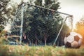 Lonely football gate or soccer goal in neglected on field with f