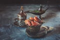 Old vase with dates and a Cup of tea. Beautiful still life for a Muslim holiday