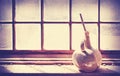 Old vase on grungy wooden window. Royalty Free Stock Photo