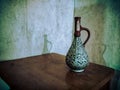 Old vase on a wooden table. Royalty Free Stock Photo