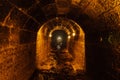 Old vaulted flooded round underground drainage sewer tunnel with dirty sewage water Royalty Free Stock Photo