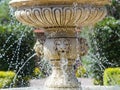 Old Venetian fountain in the park. The water flows beautifully