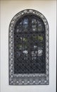 Old Venetian window with black iron grid