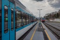 Old versus new passenger train standing on a platform. Concept of modernisation of rolling stock on railways Royalty Free Stock Photo