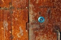 Old very rusty metal door background texture with new stainless keyhole Royalty Free Stock Photo