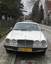 Old classic veteran ebony white Jaguar V12 Sovereign sedan executive parked