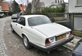 Old classic veteran ebony white Jaguar V12 Sovereign sedan executive parked