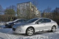 Classic old youngtimer French convenient car silver Peugeot 407 parked