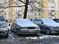 Old veteran dented big Swedish hatchback silver grey car Volvo 850 under snow cover