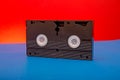 Old vhs video cassette tape  photo on red and blue background Royalty Free Stock Photo