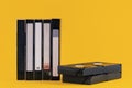 Old VHS video tapes - cassettes, isolated on yellow color background