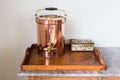 Old victorian copper tea urn and tea caddy on a wooden tray