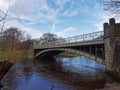 An old Victorian Metal Road Bridge crossing the River Wharfe at Ilkley Town Royalty Free Stock Photo