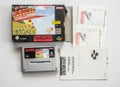 Old video Super Nintendo game cartridge, box and papers