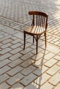 Old Viennese chair on the cobbles in the setting sun