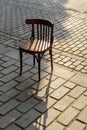 Old Viennese chair on the cobbles in the setting sun