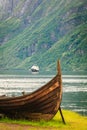 Old viking boat and ferryboat in norwegian fjord Royalty Free Stock Photo