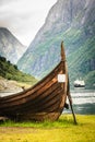 Old viking boat and ferryboat in norwegian fjord Royalty Free Stock Photo