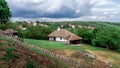 Old vilage house and cloudy sky.