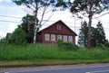 An old village house near the road on a Sunny summer day. Royalty Free Stock Photo