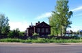 An old village house near the road on a Sunny summer day. Royalty Free Stock Photo