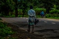 Picture of a old village man walking alone on the path in monsoon season in India Royalty Free Stock Photo