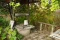 An old village well with a bench. Rural motifs. Concept: time to relax and reflect. Royalty Free Stock Photo