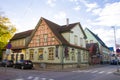 Old village wooden house in Parnu, Estonia. Village near baltic sea, resort for summer holidays. People in the street