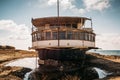 Old vintage abandoned rusted ship run aground after shipwreck accident in beginning of XX century in Crimean coast on sand beach Royalty Free Stock Photo